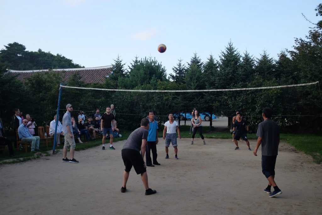 Tourists play volleyball with north Koreans on a tour